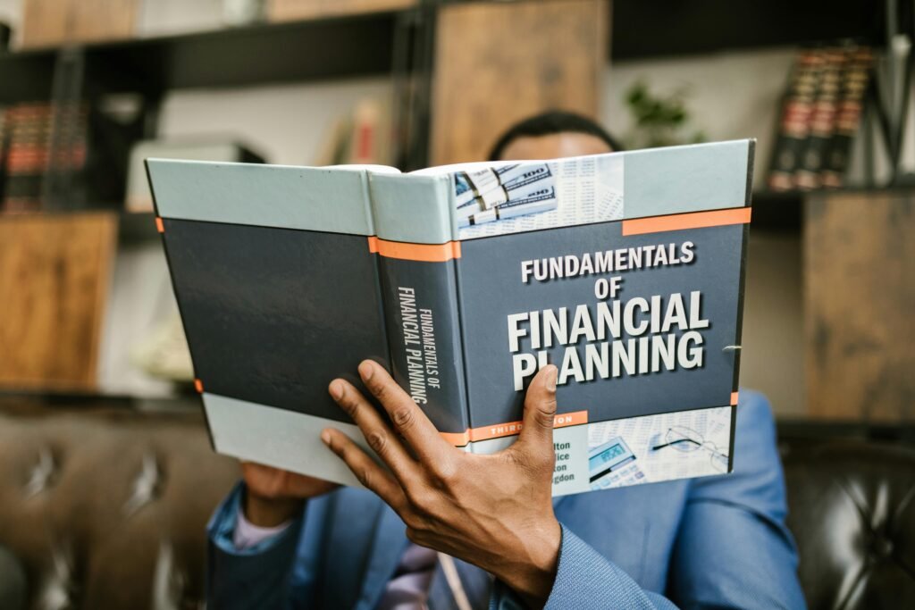 man holding a book of financial planning